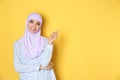 Portrait of young Muslim woman in hijab against color background. Royalty Free Stock Photo