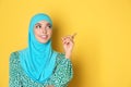 Portrait of young Muslim woman in hijab against color background. Royalty Free Stock Photo