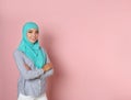 Portrait of young Muslim woman in hijab against color background Royalty Free Stock Photo