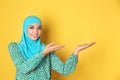 Portrait of young Muslim woman in hijab against color background.