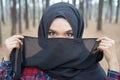 Portrait of young muslim woman scottish shirt lift hand take cloth off the face