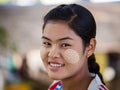 Portrait young Myanmar girl with thanaka on her smile face is happiness. Burma