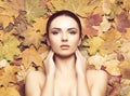 Portrait of young, natural and healthy woman over autumn background. Healthcare, spa, makeup and face lifting concept. Royalty Free Stock Photo