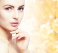 Portrait of young, natural and healthy woman over yellow autumn background. Healthcare, spa, makeup and face lifting Royalty Free Stock Photo