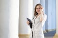 Portrait of a young nurse, medical university student girl stands with phonendoscope and documents, happy female doctor in uniform Royalty Free Stock Photo