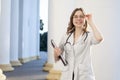 Portrait of a young nurse, medical university student girl stands with phonendoscope and documents, happy female doctor in uniform Royalty Free Stock Photo