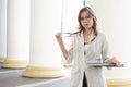 Portrait of a young nurse, medical university student girl stands with phonendoscope and documents, happy female doctor in uniform Royalty Free Stock Photo