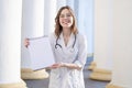 Portrait of a young nurse, medical university student girl stands with phonendoscope and documents, happy female doctor in uniform Royalty Free Stock Photo