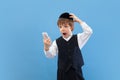 Portrait of a young orthodox jewish boy isolated on blue studio background, meeting the Passover Royalty Free Stock Photo