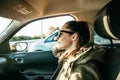 Portrait of a young passenger girl inside the car.