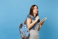 Portrait of young pensive woman student in denim clothes with backpack taking exam thinking about test holding notebook Royalty Free Stock Photo