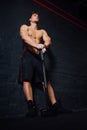 Portrait of a young physically fit man workout at gym with hammer. muscular athletic . Royalty Free Stock Photo