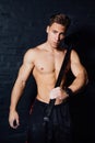 Portrait of a young physically fit man workout at gym with hammer. muscular athletic . Royalty Free Stock Photo