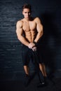 Portrait of a young physically fit man workout at gym with hammer. muscular athletic . Royalty Free Stock Photo