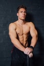 Portrait of a young physically fit man workout at gym with hammer. muscular athletic . Royalty Free Stock Photo