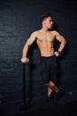 Portrait of a young physically fit man workout at gym with hammer. muscular athletic . Royalty Free Stock Photo