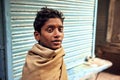 Portrait of young poor homeless man on abandoned street of indian city