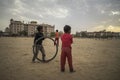 Portrait of young poor kid playing with bicycle wheel in India Royalty Free Stock Photo