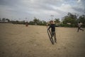 Portrait of young poor kid playing with bicycle wheel in India Royalty Free Stock Photo