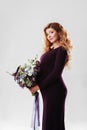 Portrait of young pregnant woman with big flower in her hand. Royalty Free Stock Photo