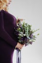 Portrait of young pregnant woman with big flower in her hand. Royalty Free Stock Photo