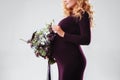 Portrait of young pregnant woman with big flower in her hand. Royalty Free Stock Photo