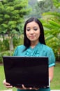 Portrait young pretty Asian muslim college girl with laptop and smile