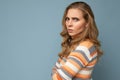 Portrait of young pretty beautiful angry grumpy dissatisfied blonde woman with sincere emotions wearing casual striped Royalty Free Stock Photo