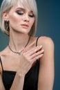 Portrait young pretty blond woman in luxury jewelry, lifestyle rich people concept, close up Royalty Free Stock Photo
