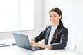 Portrait of young pretty business woman with laptop in the office Royalty Free Stock Photo