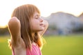 Portrait of young pretty child girl relaxing outdoors on warm summer day Royalty Free Stock Photo