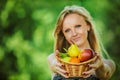 Portrait of young pretty fair-haired woman holding basket full o Royalty Free Stock Photo