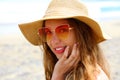 Portrait of young pretty fashion woman with straw hat and sunglasses on the beach. Vacation at sea, summer holidays Royalty Free Stock Photo