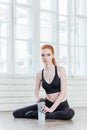 Portrait of young pretty fitness woman with water bottle