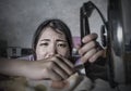 Portrait of young pretty frustrated and stressed Asian Chinese woman looking sad at iron working at home kitchen ironing clothes t Royalty Free Stock Photo