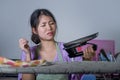 Portrait of young pretty frustrated and stressed Asian Korean woman holding iron working at home kitchen ironing clothes desperate Royalty Free Stock Photo