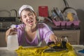 Portrait of young pretty frustrated and stressed Asian Korean woman working at home kitchen ironing clothes desperate and overwhel Royalty Free Stock Photo