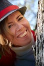 Portrait of young pretty funny smiling girl in male hat in sunny autumn day. Young happy woman having fun outdoor Royalty Free Stock Photo