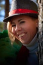 Portrait of young pretty funny smiling girl in male hat in sunny autumn day. Young happy woman having fun outdoor Royalty Free Stock Photo