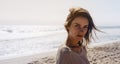 Portrait young pretty girl looking on summer beach, hipster in sand coastline on background seascape horizon blue sun ocean Royalty Free Stock Photo