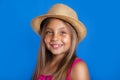 Portrait of young pretty girl in pink dress and hat on blue background .Summer vacation and travel concept Royalty Free Stock Photo