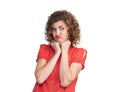 Portrait of a young pretty girl in a red dress with an emotional expression of resentment, isolated on white background. Pout her