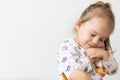 A portrait of a young pretty girl smiling and hugging her teddy bear over white background. Place for text, copy space Royalty Free Stock Photo