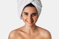 Portrait of young pretty girl smiling with towel on her head. Woman with towel on her head, close-up. Royalty Free Stock Photo