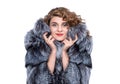 Portrait of a young pretty happy woman in a silver fox fur coat. Isolated on white background. Royalty Free Stock Photo