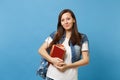 Portrait of young pretty pleasant woman student in denim clothes with backpack holding school books and ready to learn