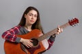 Portrait of a young pretty woman with an acoustic guitar in her hands. Close up Royalty Free Stock Photo