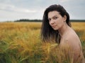 Portrait of young pretty woman without bra in barley Royalty Free Stock Photo