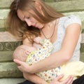 Portrait of young pretty woman breastfeeding her suckling baby Royalty Free Stock Photo