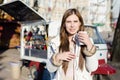 Portrait of young pretty woman with a cup of hot drink on sunny outdoors background Royalty Free Stock Photo